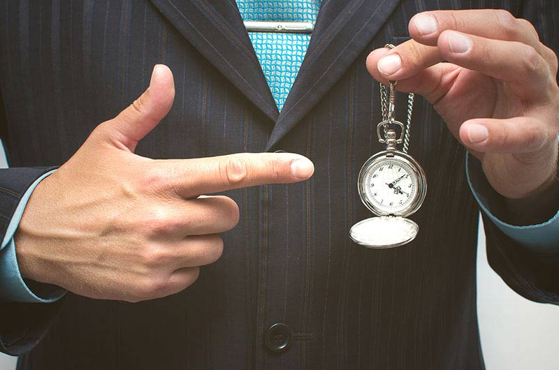 Businessman holding a pocket watch