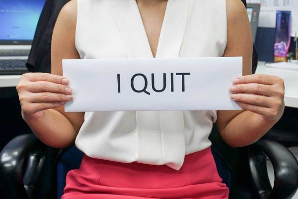 business woman holding i quit sign