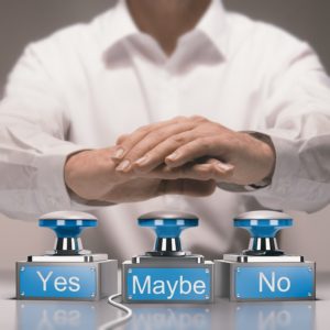 Businessman pressing yes, no or maybe buzzers