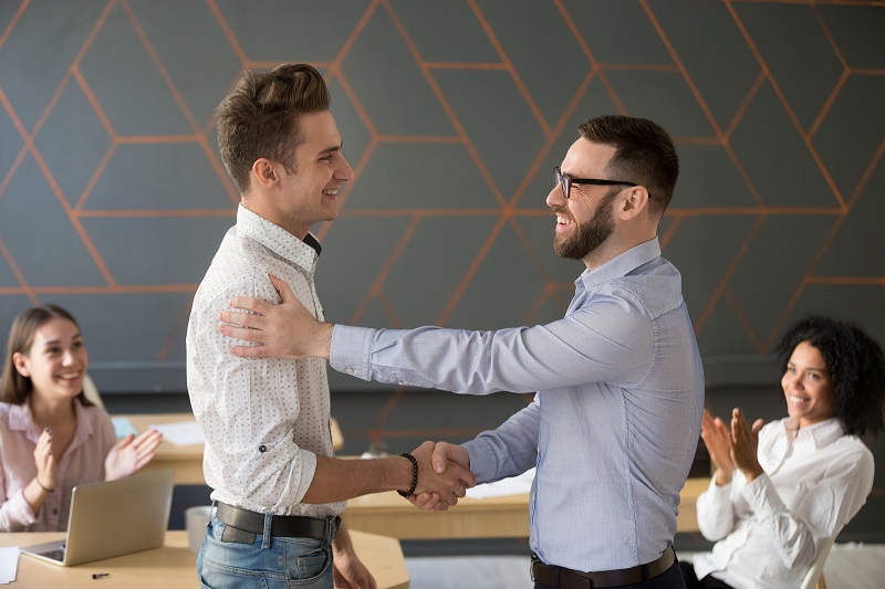 Manager shaking hands with an employee