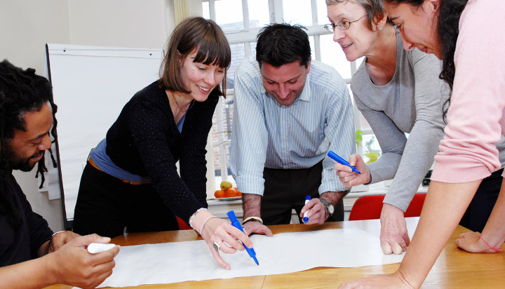 Leaders writing on a flipchart
