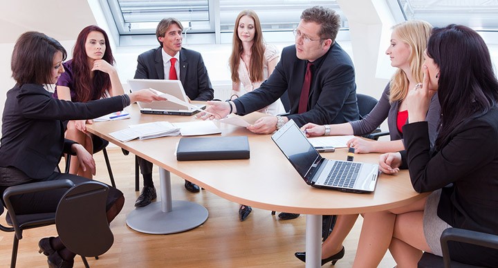 Business meeting with a chairperson trying to control it