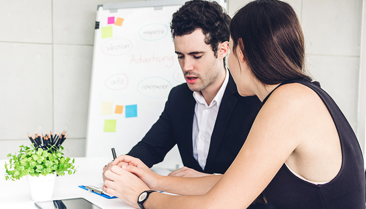 A manager and a staff member having a coaching session