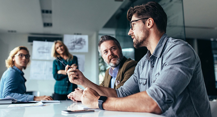 Man influencing others at a team meeting