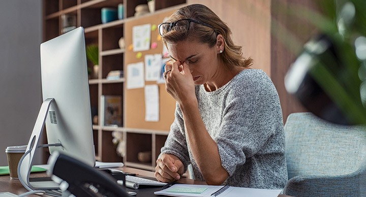 Woman at work stressed out because of work