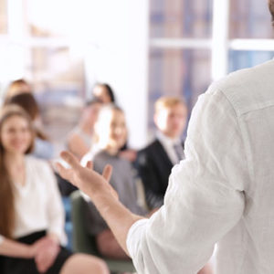 Business trainer giving presentation to group of people