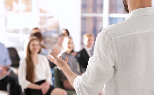 Business trainer giving presentation to group of people